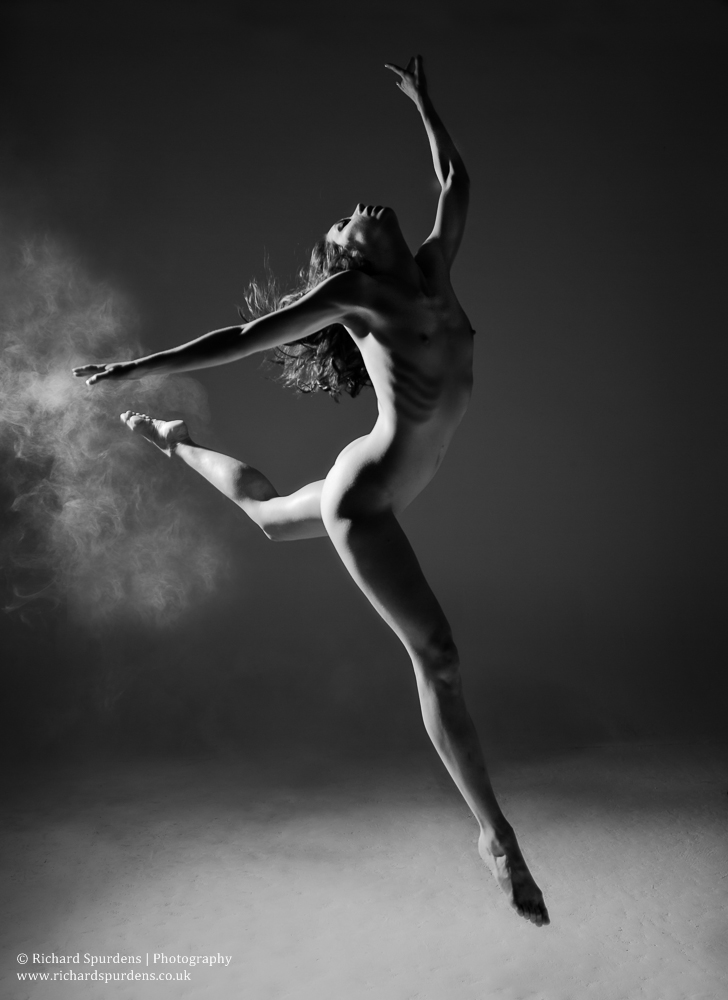 Dance Photography - Dance Photographer - monochrome fine art nude image of dancer captured in mid air making a forward leep
