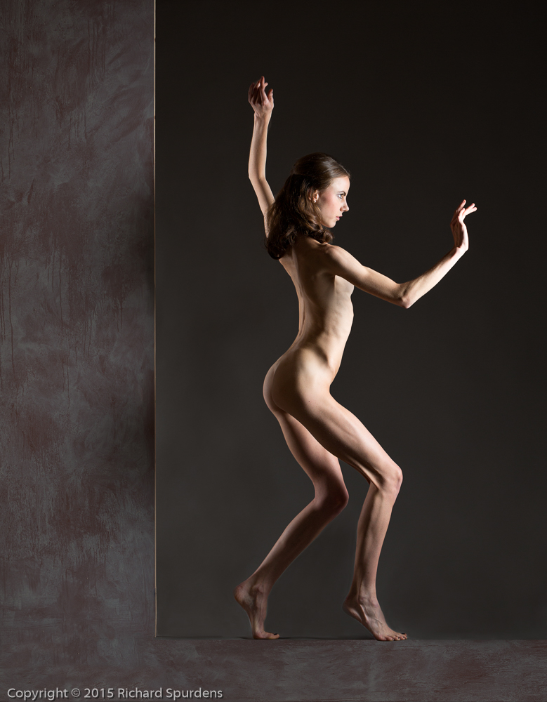Artistic nude photographer - artistic nude photography - artistic nude model balanceing on a box with a panel to the left hand side making look she is on an L shape