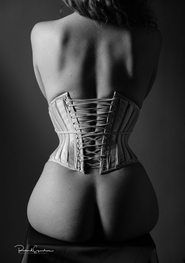 Artistic nude photographer - artistic nude photography monochrome image of models back and the corset lacing of the corset she is wearing