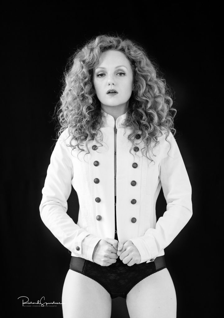 fashion photographer - fashion photography - monochrome image of model wearing a white military style jacket and black pants