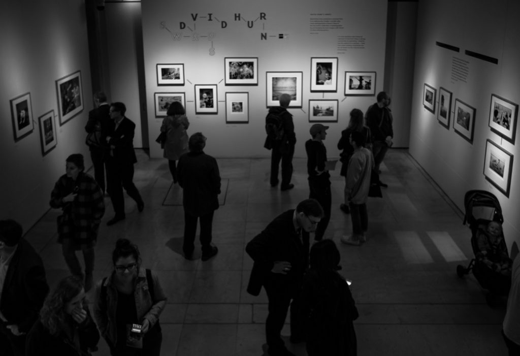 travel photography - travel photograher - images from a visit to photo london this one in monochrome showing visitors to the david hern swoops exhibition