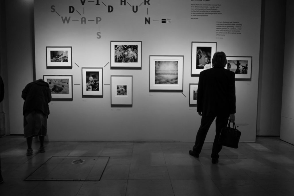 travel photography - travel photograher - images from a visit to photo london this one in monochrome showing visitors to the david hern swoops exhibition