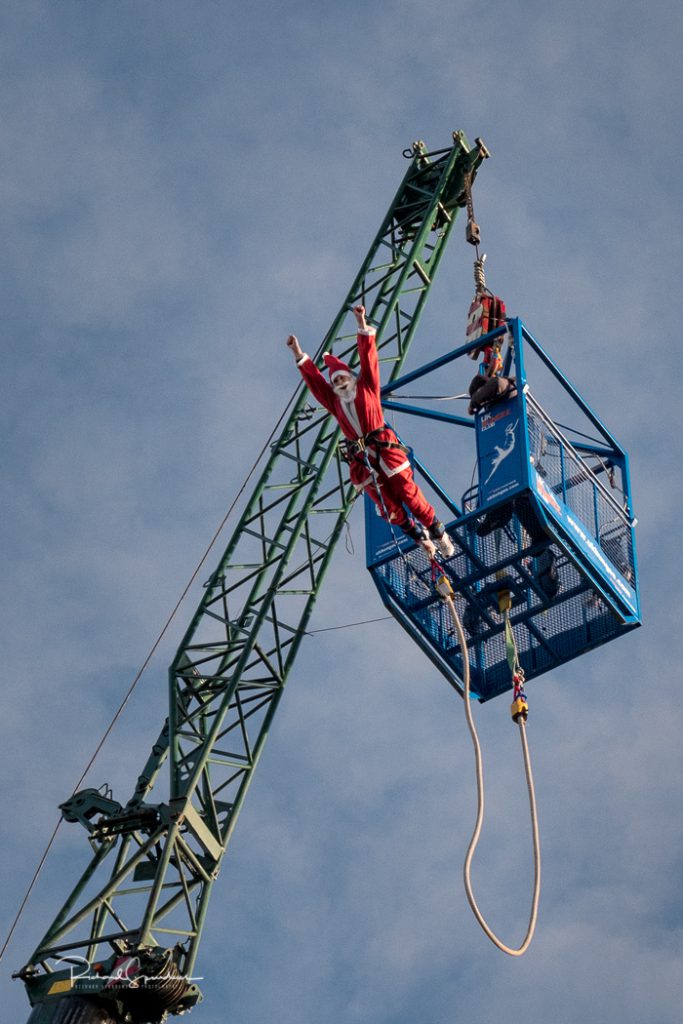 a bungy jumping santa clauss as he leaves the jump platform