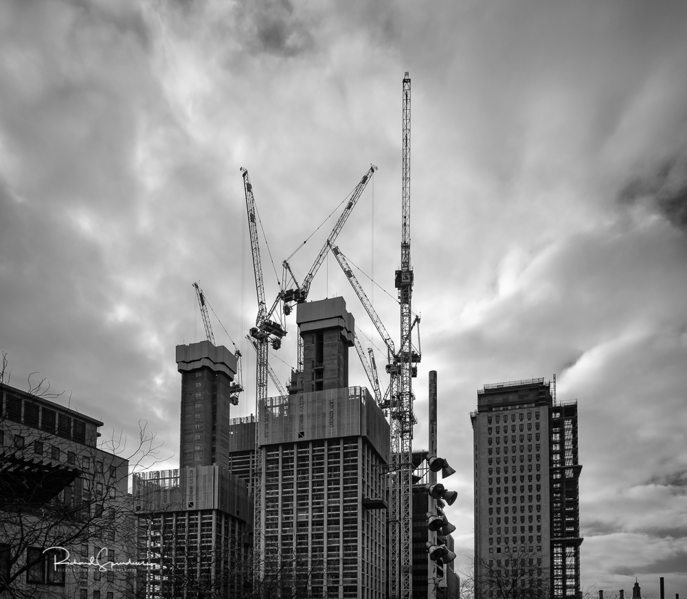 travel photography - travel photograher - images from a visit to london this one in monochrome showing the new towers been constructed surrounded by the tower cranes reaching up to the sky