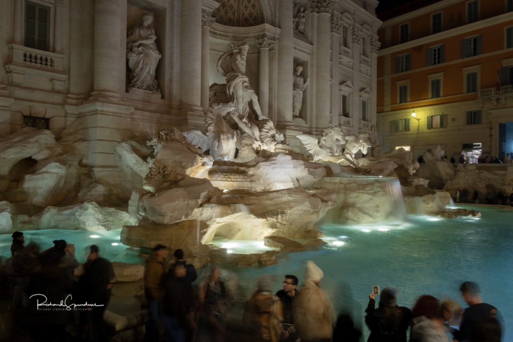 travel photography - travel photograher - colour image from a visit to rome this one from the trevi fountain square shoot around 20:00 still lots of tourists stood in front of the fountain