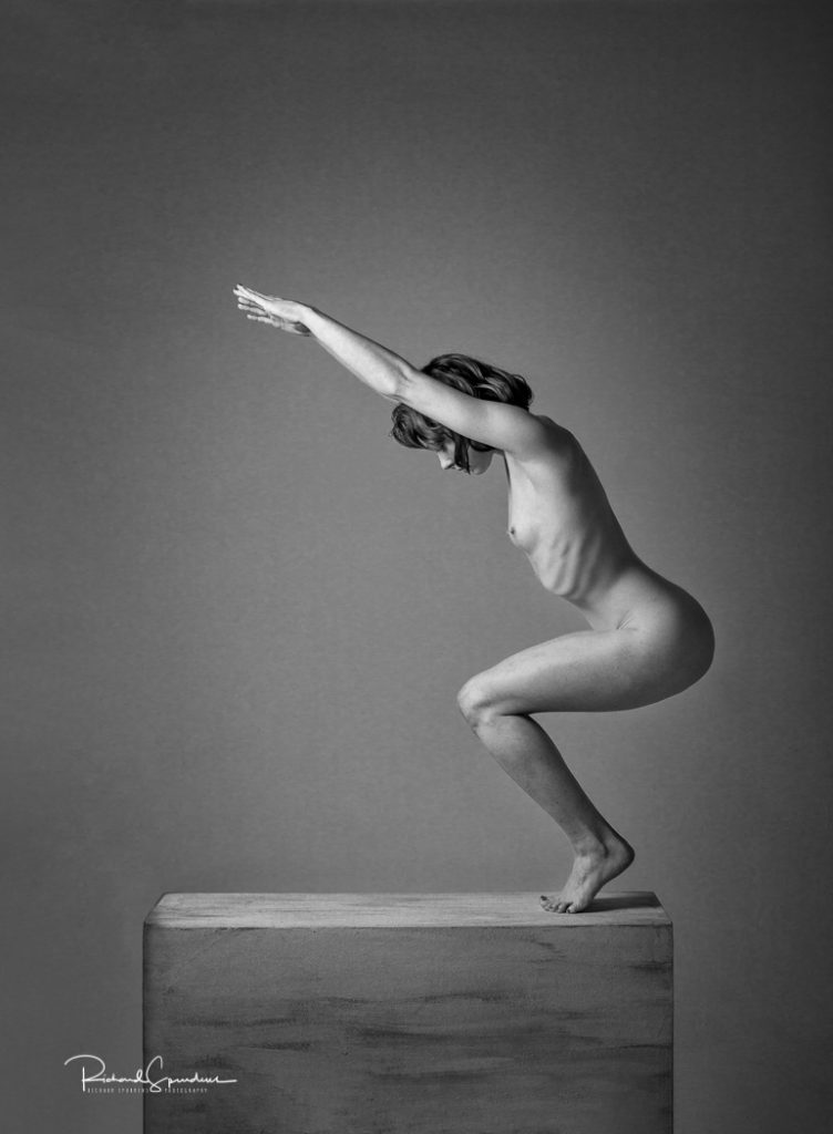 Fine Art Nude Photography - Fine Art Nude Photographer - monochrome image showing a stong artistic nude figure shape standing on a plinth