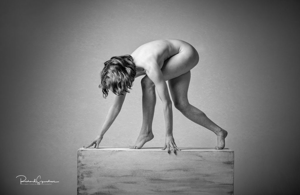 Fine Art Nude Photography - Fine Art Nude Photographer - monochrome image showing a stong artistic nude figure shape standing on a plinth