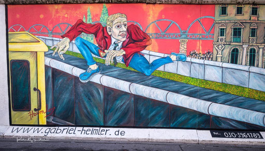 street photography - street photographer - image showing the wall mural entitled the wall jumper - berlin wall