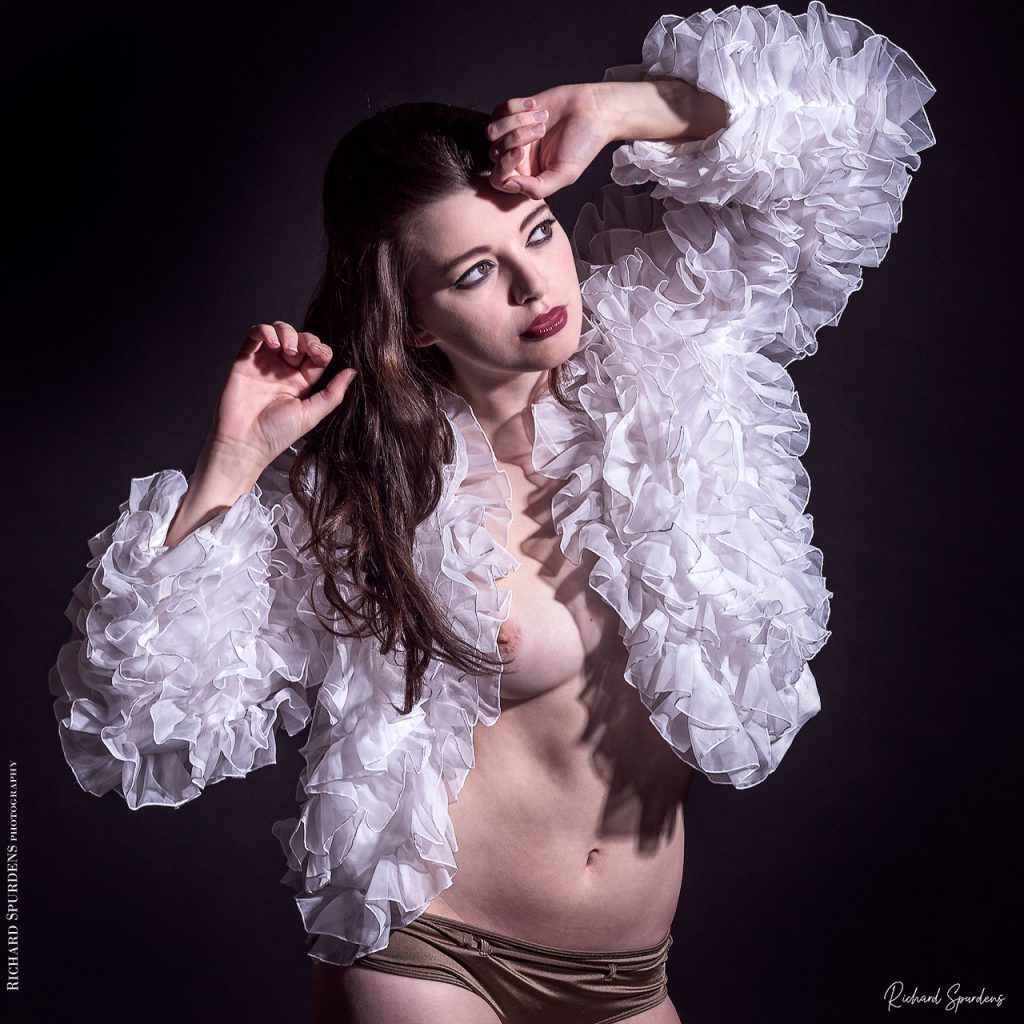 Fashion Photography - Fashion Photographer - featuring a model wearing a white ruffled scalloped jacket using a single light setup