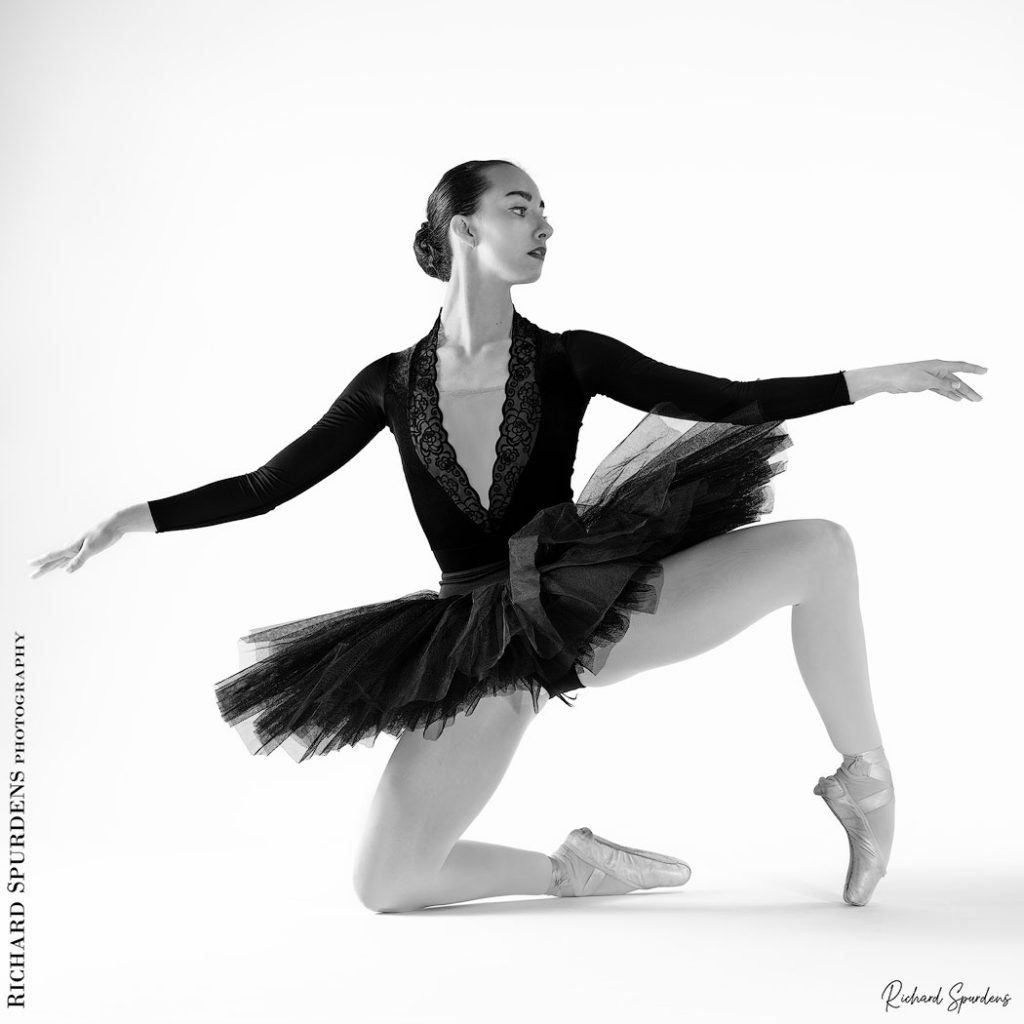 Dance Photographer - Dance photography - dancer Erica Mulkern wearing a black tutu as she makes some kneeling floor shapes